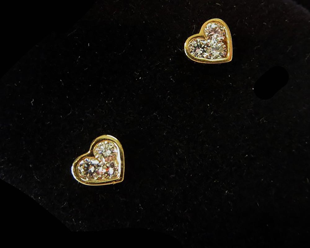 earrings designs as gold hearts with diamonds in the middle